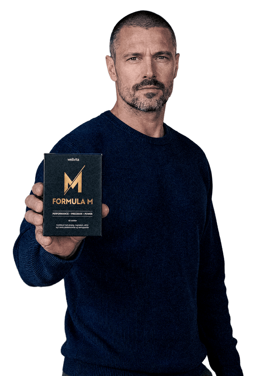 A man in a dark navy blue sweater holds up a black product box labeled 'mMUTE FORMULA M' with gold lettering against a solid white background.